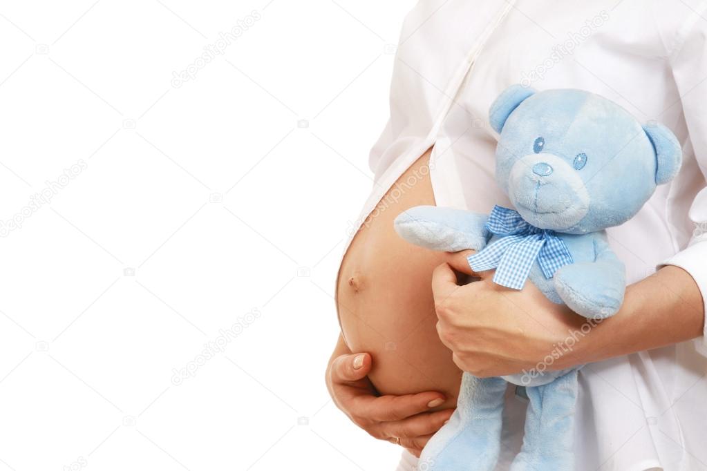 Pregnant woman holding a toy