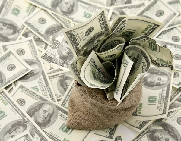Canvas money sack with one hundred dollar bills — Stock Photo, Image