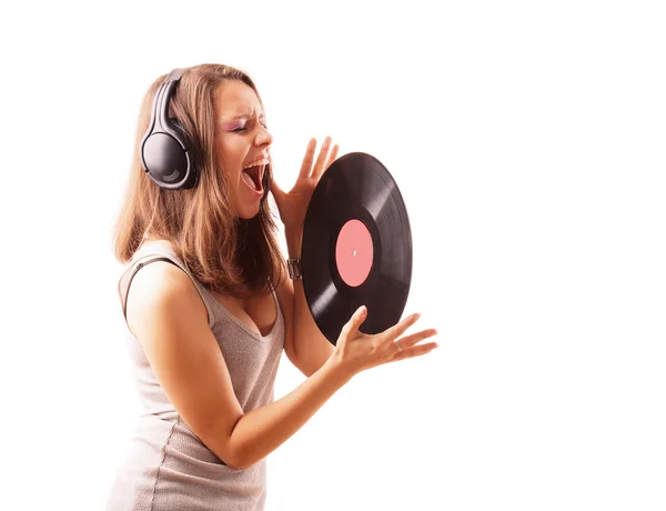 Girl in ear-phones with vinyl is singing — Stock Photo, Image