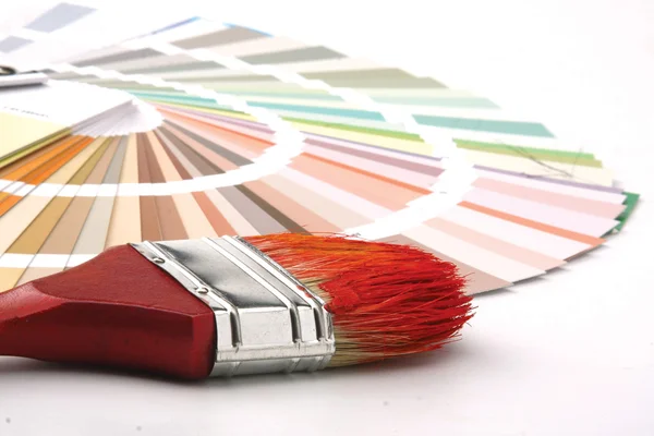 Paintbrush and a colorful paint — Stock Photo, Image