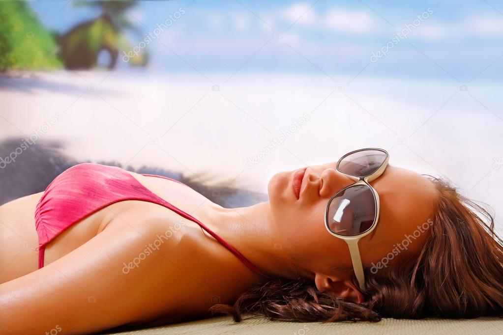 Woman taking a sun bath on a beach