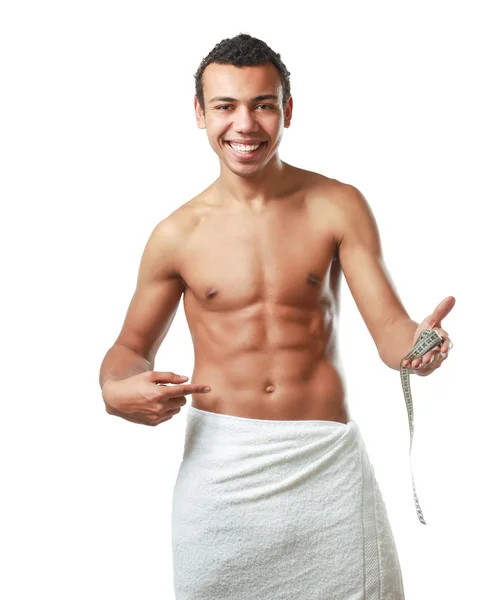 Young man  with a towel with tape measuring — Stock Photo, Image