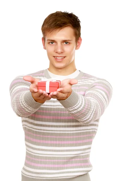 Young man holding red gift box — Stock Photo, Image