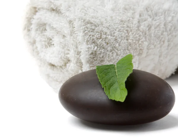 Stone, towel and leaf of mint — Stock Photo, Image