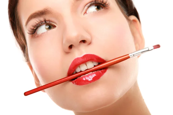 Woman's lips holding make up brush — Stock Photo, Image