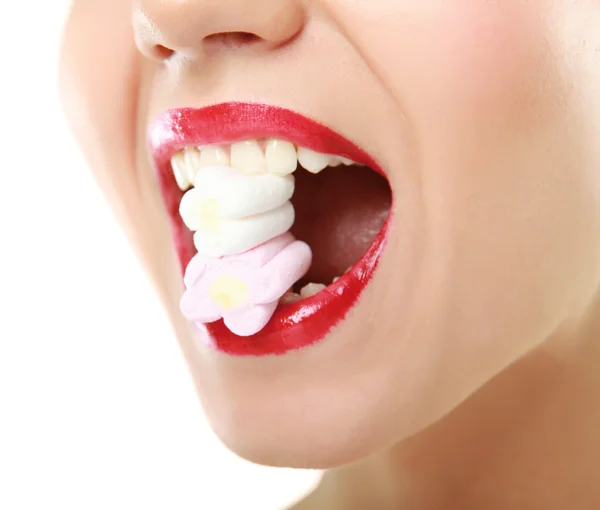 Woman holding candy in mouth — Stock Photo, Image