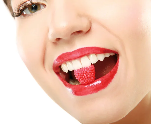 Woman holding candy in mouth — Stock Photo, Image