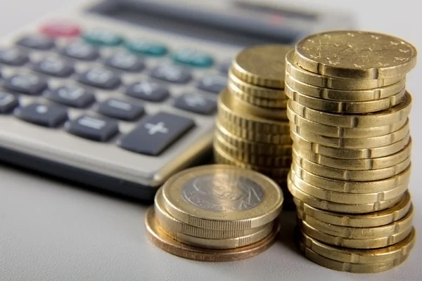 Coins and calculator. — Stock Photo, Image