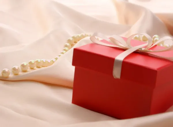 Gift on silk. — Stock Photo, Image