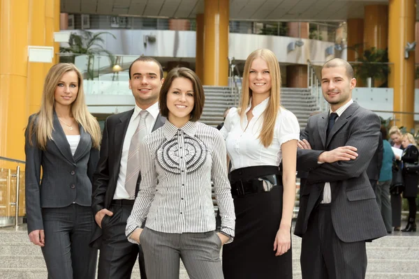 Successful businessman standing with his staff — Stock Photo, Image