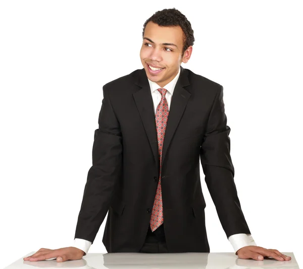 Young man standing near desk — Stock Photo, Image