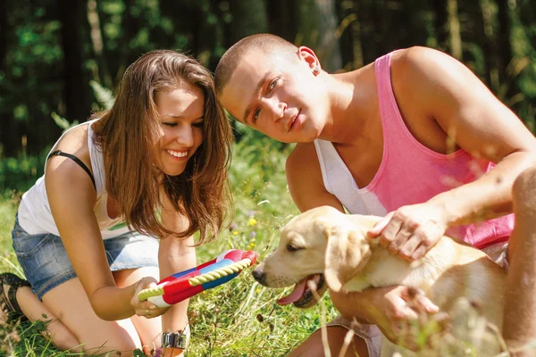 Couple With Their Puppy. — Stock Photo, Image