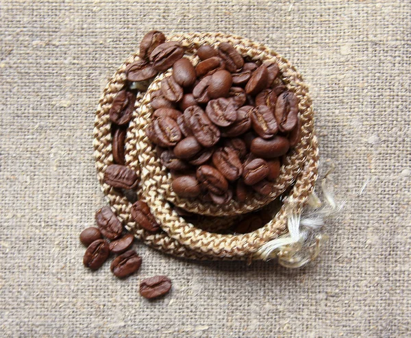 Coffee beans on a linen textute — Stock Photo, Image