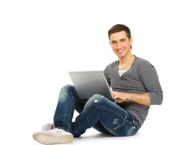 Guy sitting on the floor with a laptop — Stock Photo, Image