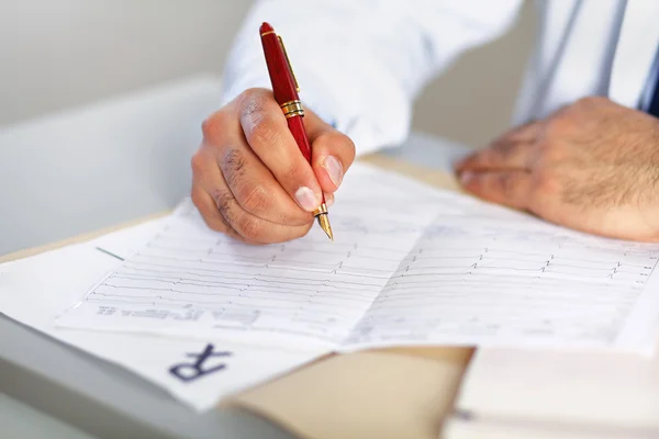 Hands of a doctor filling RX prescription — Stock Photo, Image