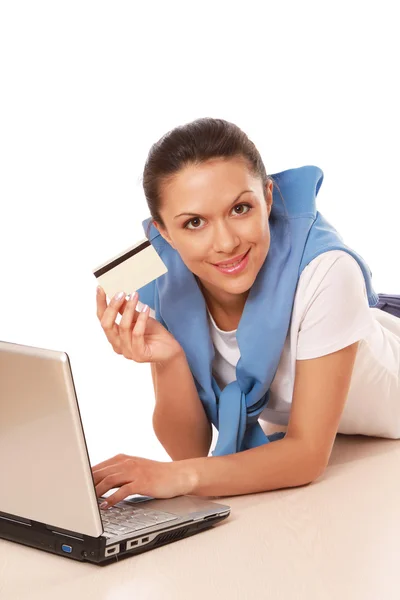 Femme avec un ordinateur portable, tenant une carte de crédit — Photo