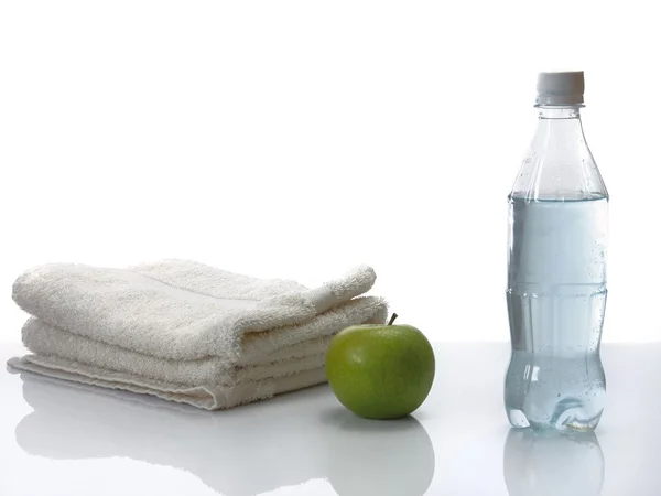 White towel,green apple and bottle of water — Stock Photo, Image