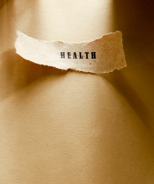 Word health written on a ripped piece of paper — Stock Photo, Image
