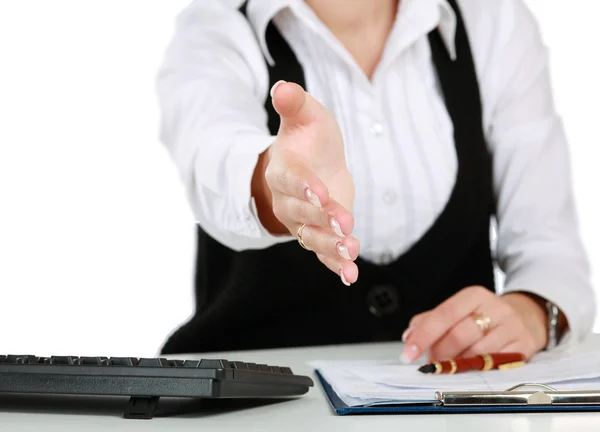 Woman sitting at the desk and offering hand — Stock Photo, Image