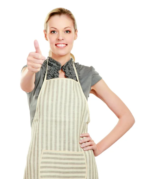 Woman in kitchen apron and gesturing thumbs up — Stock Photo, Image