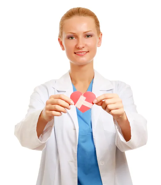 Female doctor holding a wounded paper heart — Stock Photo, Image