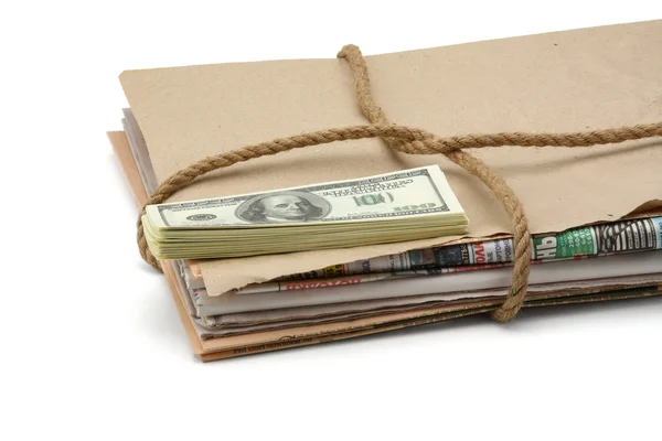 Newspaper stack and dollars. — Stock Photo, Image