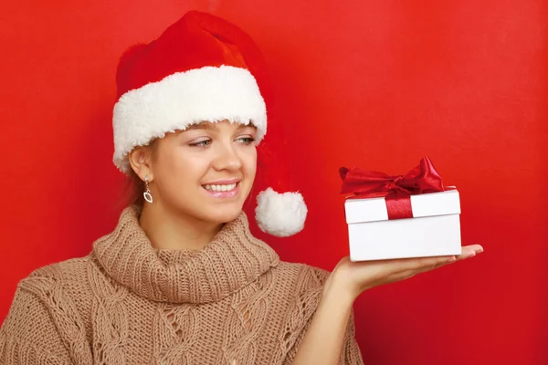 Woman on santa hat with christmas gifts — Stock Photo, Image
