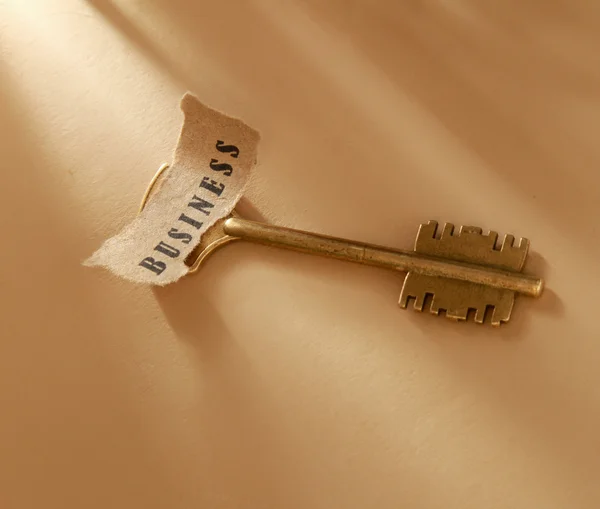 Word business written on a piece of paper and key — Stock Photo, Image