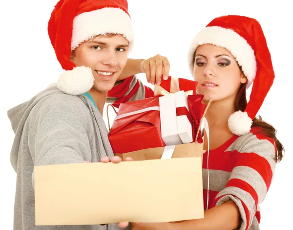 Couple in Santa hats with presents — Stock Photo, Image