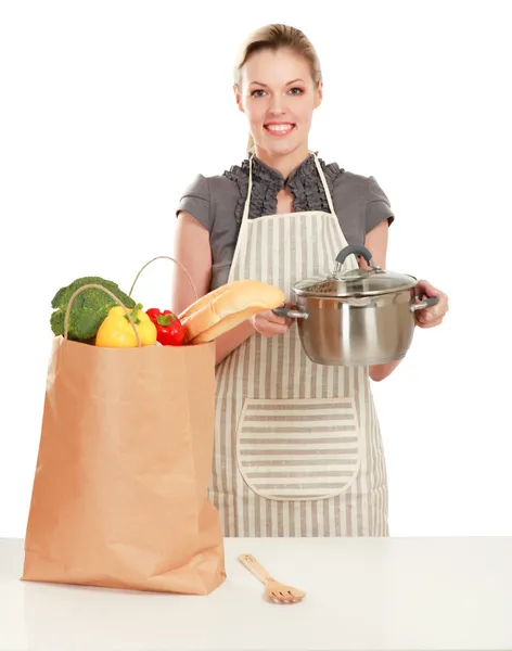 Woman in apron  with grocery bag — Stock Photo, Image