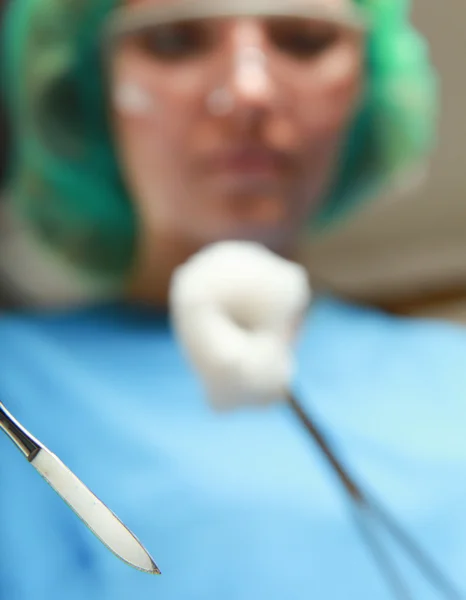 Woman surgeons holding medical instruments — Stock Photo, Image