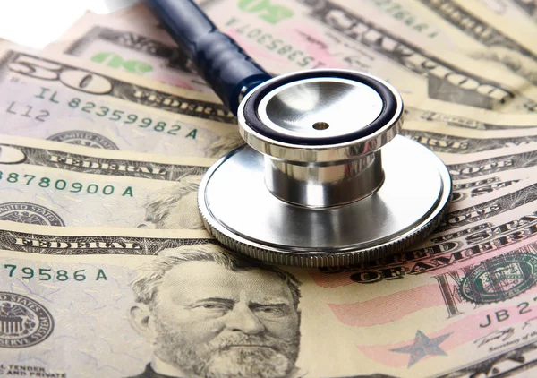 Heap of dollars with stethoscope — Stock Photo, Image