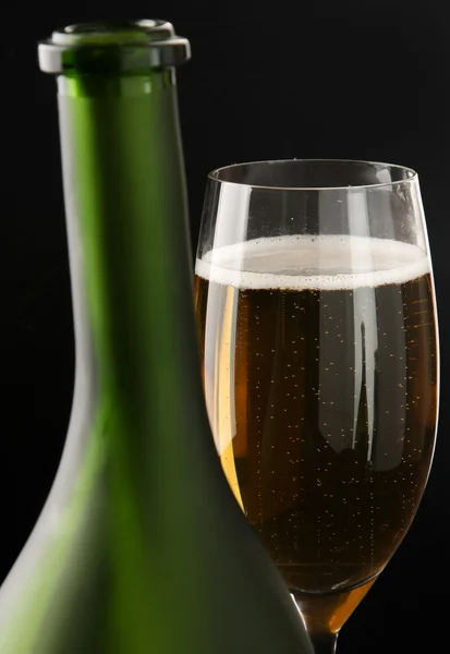 Glass of champagne near a bottle — Stock Photo, Image