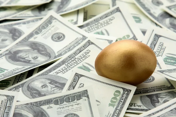 Golden egg on  dollars. — Stock Photo, Image