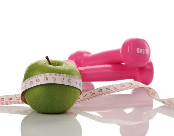 Green apple, dumbbell, tape — Stock Photo, Image