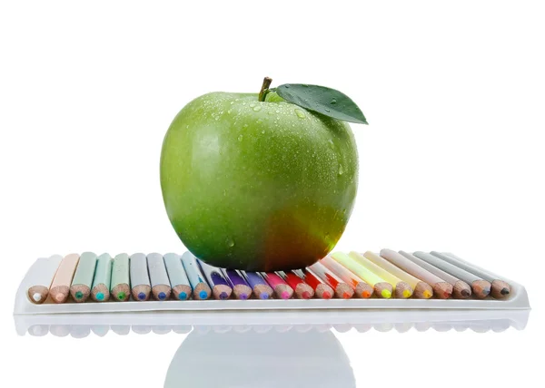 Colored pencils and  green apple — Stock Photo, Image