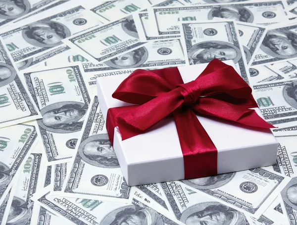 Gift on dollars background. — Stock Photo, Image