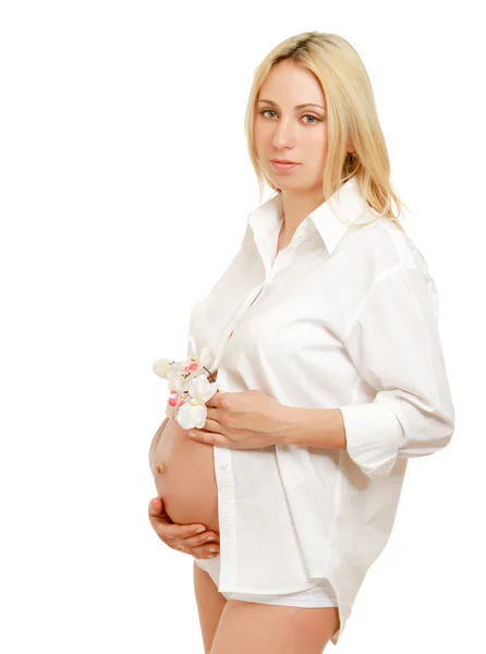 Pregnant woman with orchid Royalty Free Stock Images