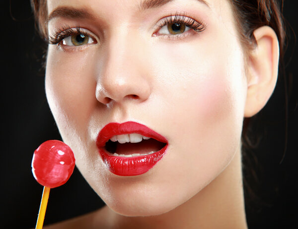 Young beautiful girl with lollipop