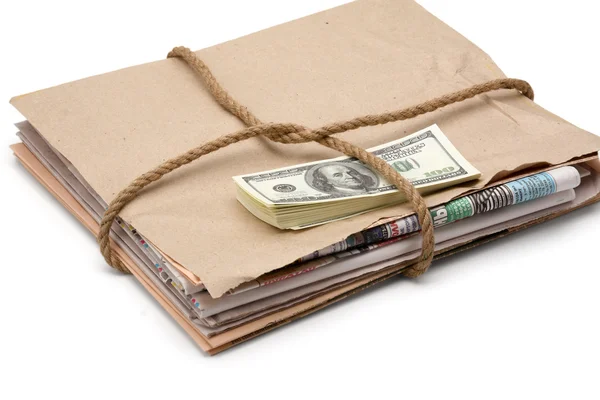 Newspaper stack and dollars — Stock Photo, Image
