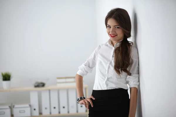 Attractive businesswoman standing in office — Stock Photo, Image