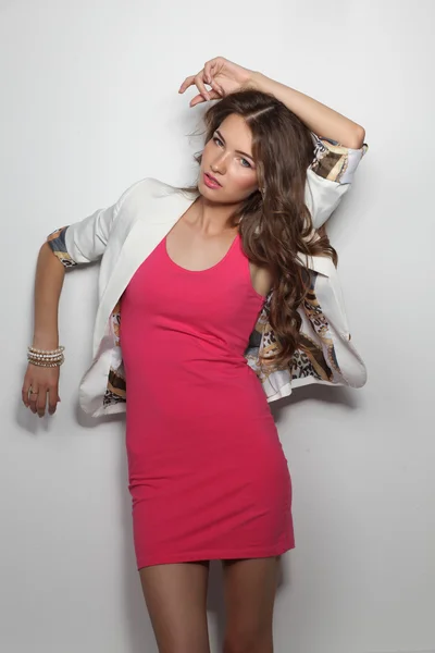 Young woman wearing a pink dress standing — Stock Photo, Image