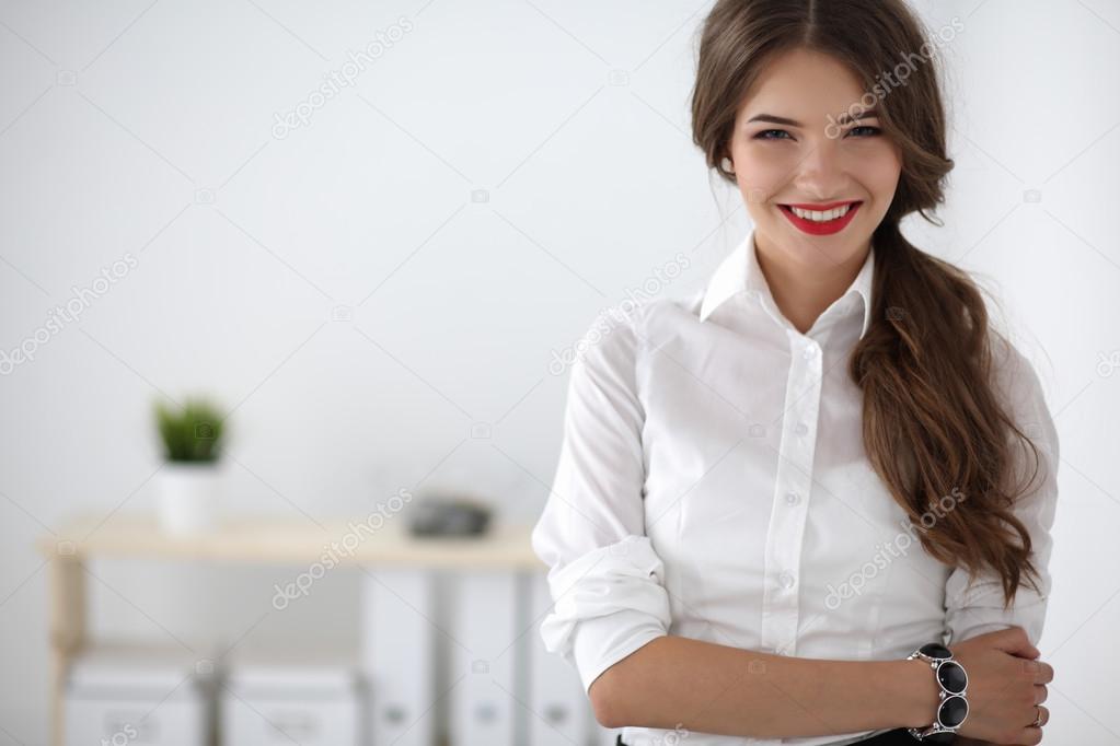 Attractive businesswoman with her arms crossed  standing in office