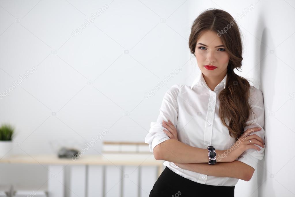 Attractive businesswoman with her arms crossed  standing in office