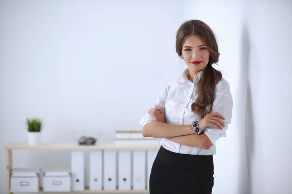 Aantrekkelijke zakenvrouw met haar armen gekruist staande in uitschakelen — Stockfoto