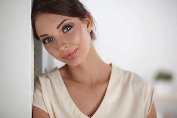 Close-up portrait of a smiling  business woman standing in her office