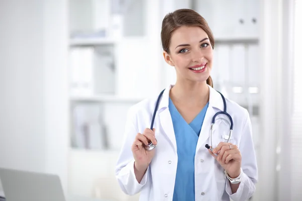 Portrait of happy successful young female doctor holding a stethoscope — Stock Photo, Image