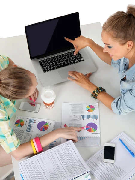 Två kvinnor arbetar tillsammans på kontoret, sitter på skrivbordet — Stockfoto