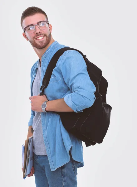 Een mannelijke student met een schooltas boeken geïsoleerd op een witte achtergrond te houden. Onderwijsaanbod. College student. — Stockfoto