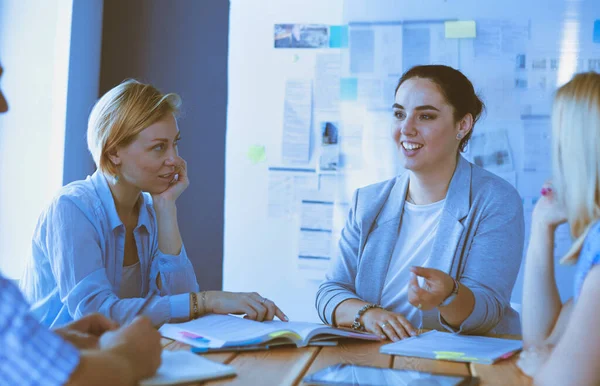 Young people studying with books on desk. Beautiful women and men working together. — Stock Photo, Image